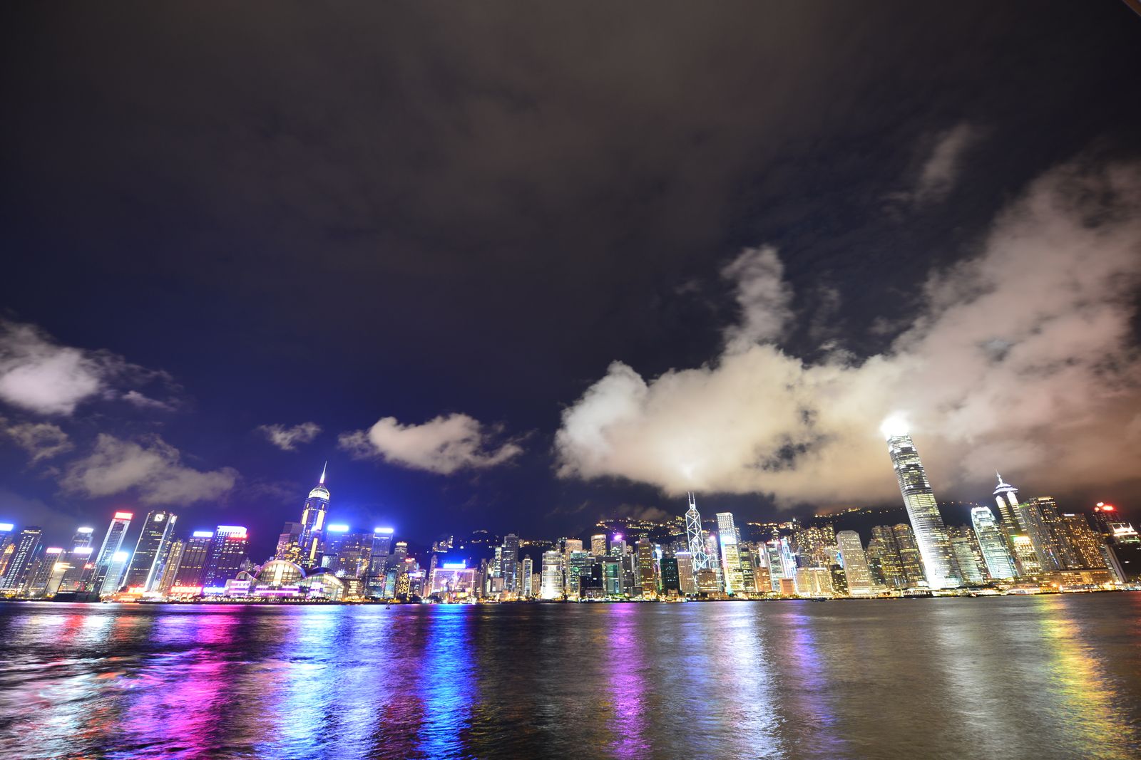 Hong Kong's skyline reflected on Victoria Harbour at night.