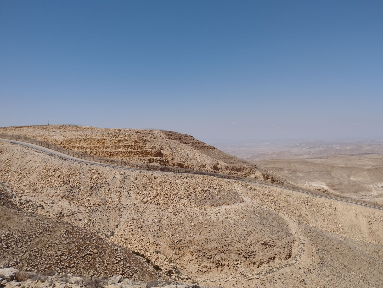 A winding road through a rocky desert landscape.