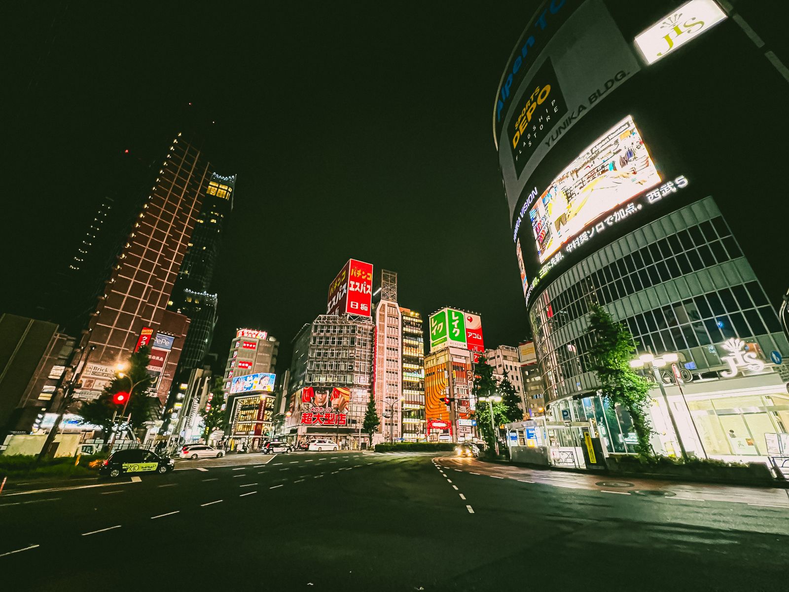 A narrow Tokyo street lit by signboards.