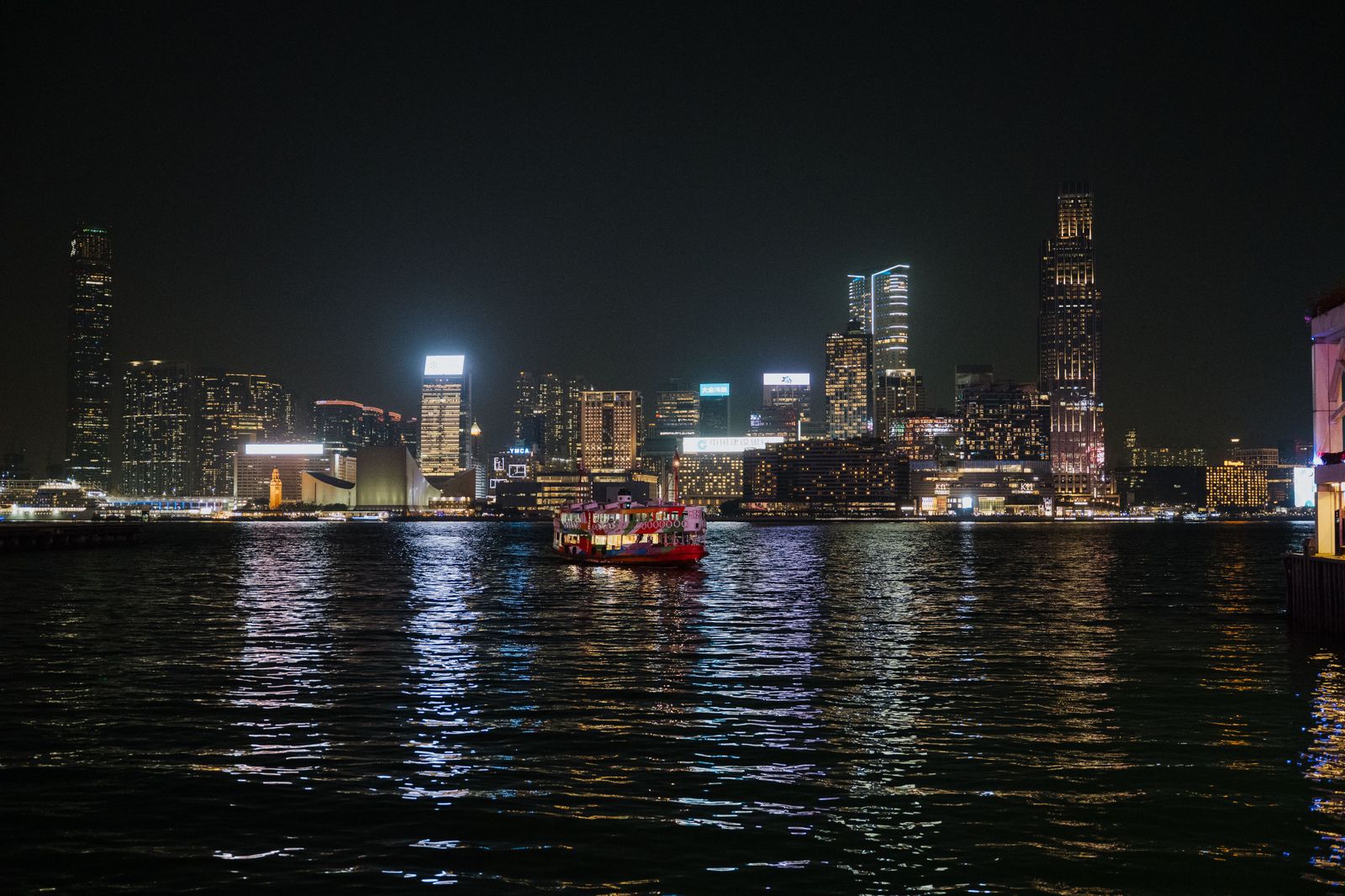 Ferries crossing Victoria Harbour beneath the lit skyline.