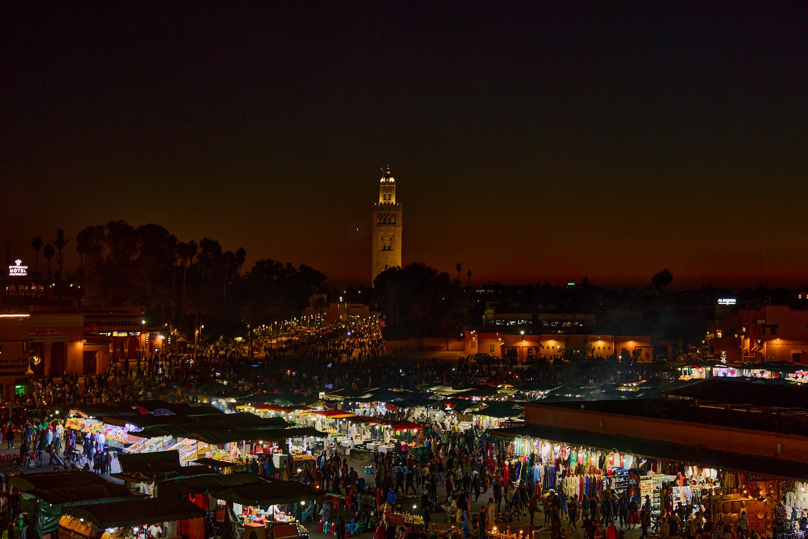 The night market in Jemaa el-Fnaa, Marrakech, lit by food stalls.